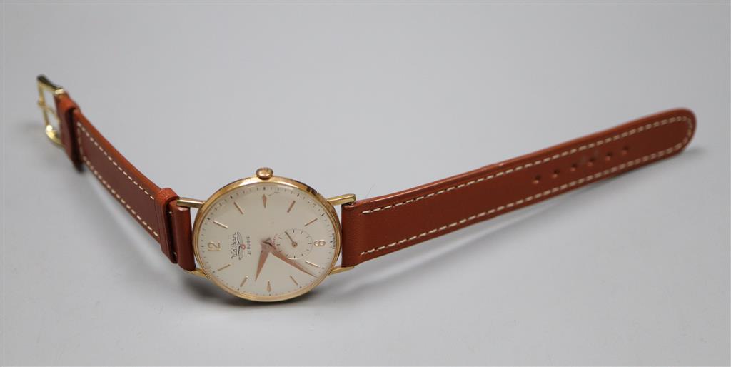 A gentlemans yellow metal and steel Waltham manual wind wrist watch, on later leather strap.